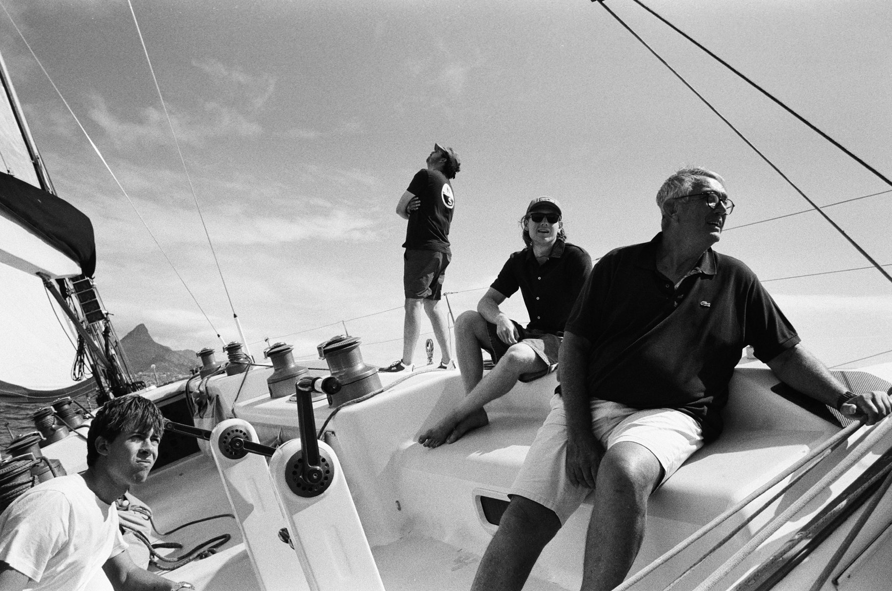Four crew on Warrior's deck with Lion's Head behind